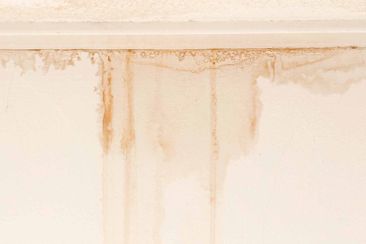 Interior wall showing vertical moisture damage stains
