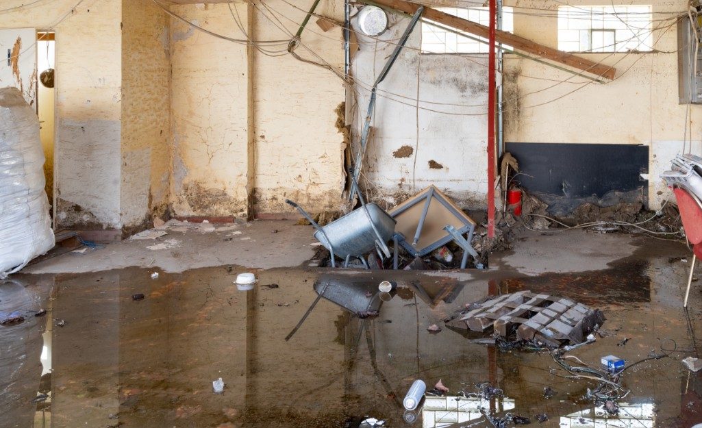 Apartment interior showing water damage and debris on the floor